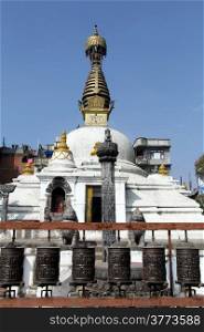 White stupa and bronze drums in Patan, Nepal
