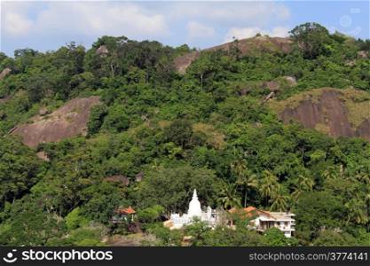 White stupa and monastery in forest in Kurunegala, Sri Lanka