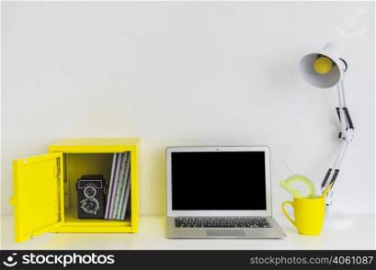 white stylish workplace white yellow colors with laptop yellow box