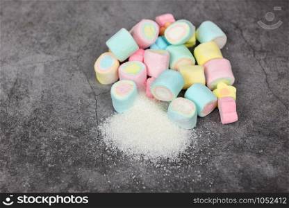 White sugar and colorful candy sweet on the table background / No sugar in diet causes obesity diabetes and other health problems concept , selective focus