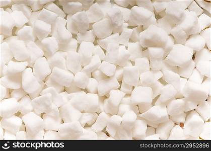 White sugar cubes arranged at the background