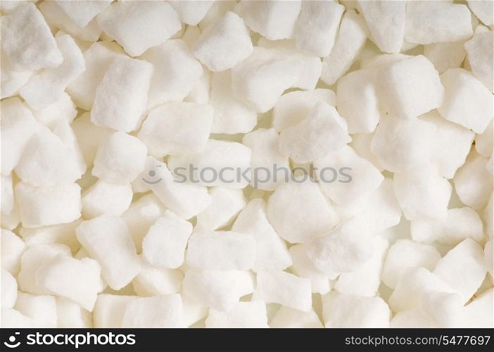 White sugar cubes arranged at the background