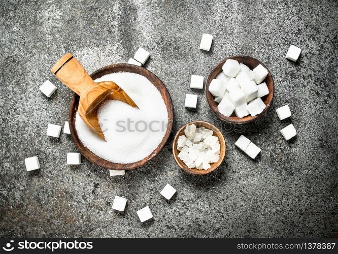 White sugar in bowls. On a rustic background.. White sugar in bowls.