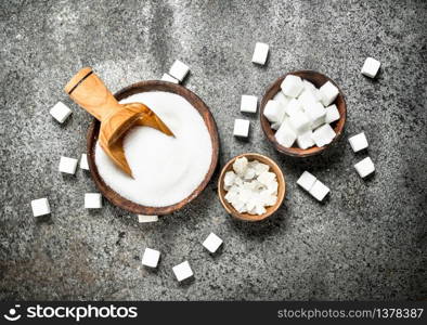 White sugar in bowls. On a rustic background.. White sugar in bowls.