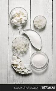 White sugar . On a white wooden background.. Refined sugar, sand, and crystalline. On white wooden background.