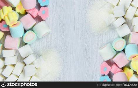White sugar , sugar cubes and colorful candy sweet on the table background top view / No sugar in diet causes obesity diabetes and other health problems concept , selective focus