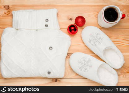 white sweater and warm slippers as a gift, objects view from above