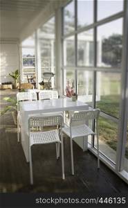 White table and chair in cargo container living room, stock photo