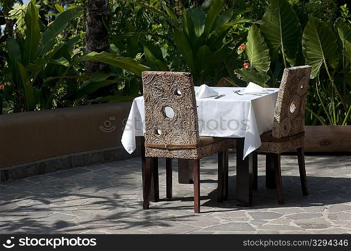 White tablecloth formal dining setting outside on the terrace