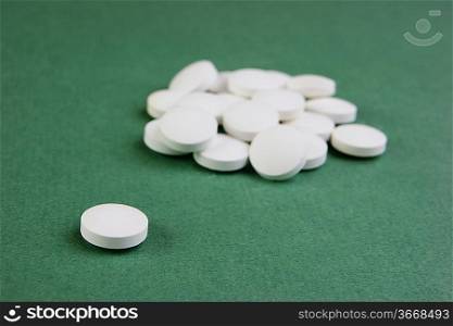 white tablets on a green background