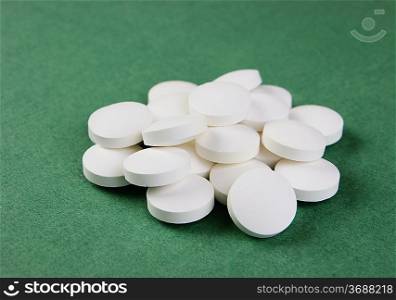 white tablets on a green background