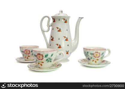 White tea service consisting of high teapot and three cups with saucers painted with dogroses isolated