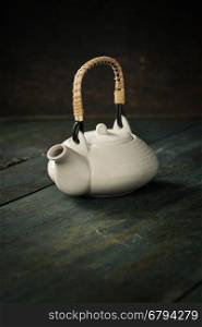 White Teapot on a wooden table