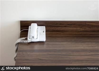 White telephone on the table in a hotel room