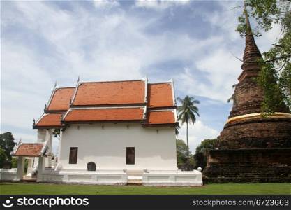 White temple and brick stupa in Wat Traphang-Thong, Sulhotai, Thailand