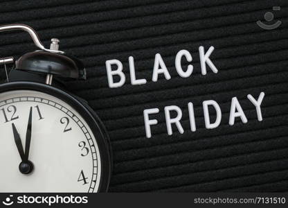 White text Black friday on black letter board and alarm clock, closeup. Concept Black friday , season sales time. Flat lay Top view Copy space Template layout for your design.. White text Black friday on black letter board and alarm clock , closeup. Concept Black friday , season sales time. Flat lay Top view Copy space Template layout for your design