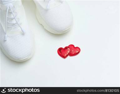 White textile sneakers on a white background, top view