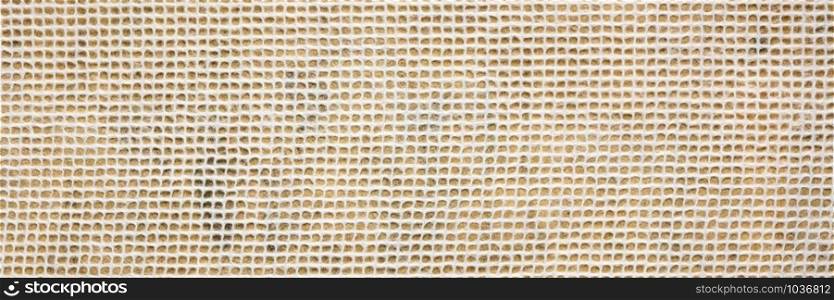 white Thai mulberry lace paper with a grid pattern against orange background, panoramic banner
