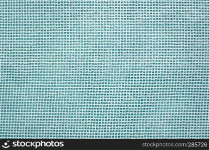 white Thai mulberry lace paper with a grid pattern against turquoise, background