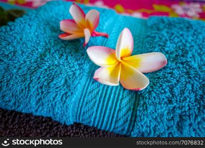 White tiare flowers on a blue towel. Zen spa background. White tiare flowers on a towel