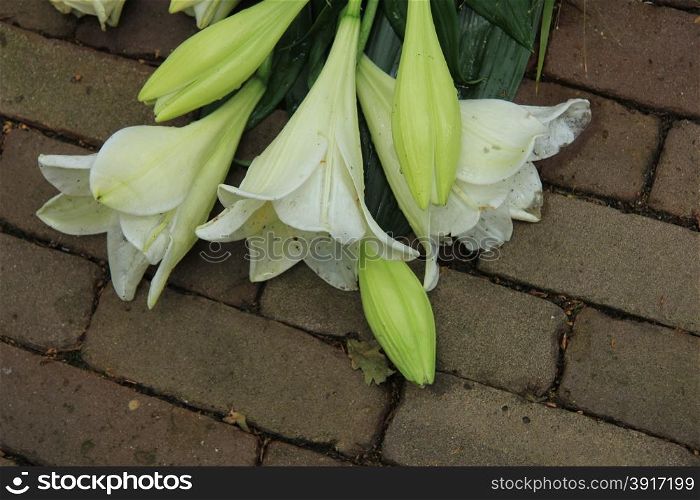 white tiger lilies in a sympathy arrangement