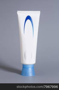 White Toothpaste Tube Isolated on Gray Background