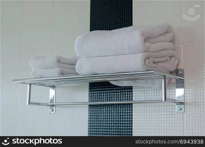 White towel on steel rail shelf