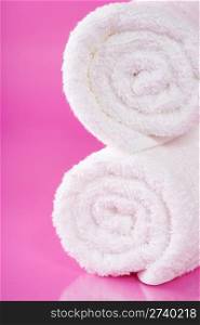 white towels on a pink background