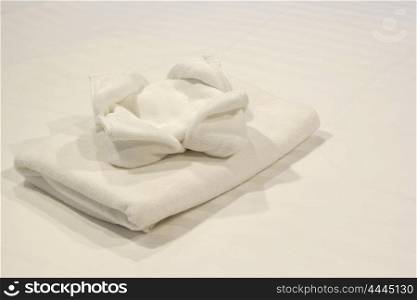 white towels on bed for guest in hotel
