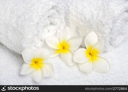 White towels with white flowers for wellness