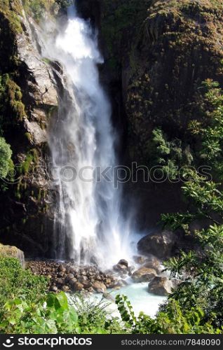 White water in waterfall and green grass in mountain Nepal