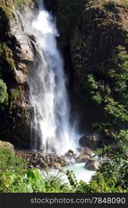 White water in waterfall and green grass in mountain Nepal