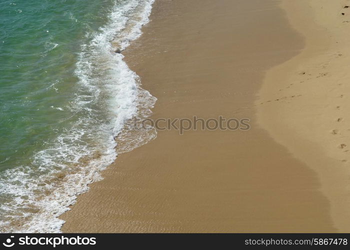 white wave in the sand at the beach