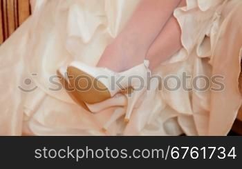 white wedding shoes against white embroidered dress
