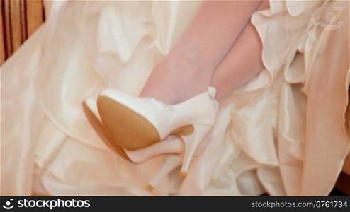 white wedding shoes against white embroidered dress