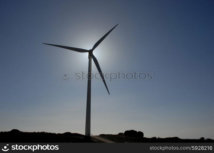 white wind turbine in the top of the mountain