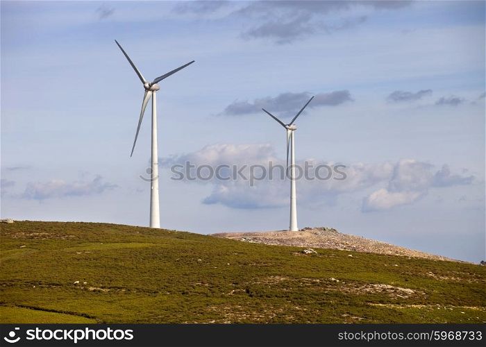 white wind turbine in the top of the mountain