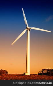 white wind turbine in the top of the mountain