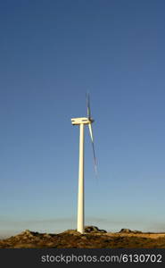 white wind turbine in the top of the mountain