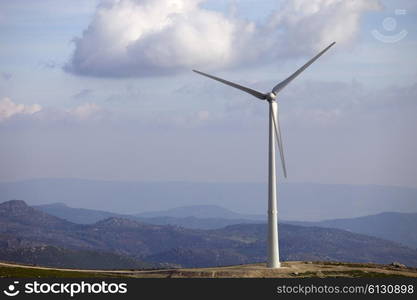 white wind turbine in the top of the mountain