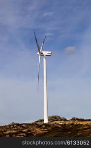 white wind turbine in the top of the mountain