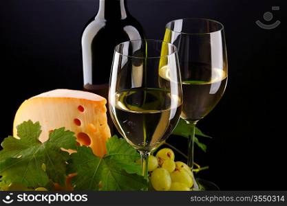 white wine and cheese on black