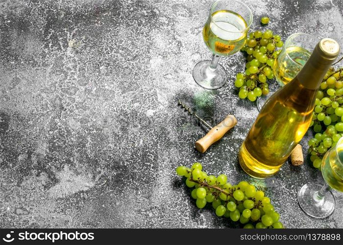 White wine from green fresh grapes. On a rustic background.. White wine from green fresh grapes.