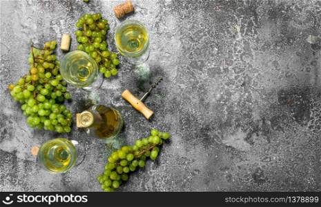 White wine from green fresh grapes. On a rustic background.. White wine from green fresh grapes.