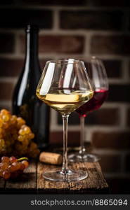 White wine in a glass with fall grapes, dark wooden background. White wine in a glass