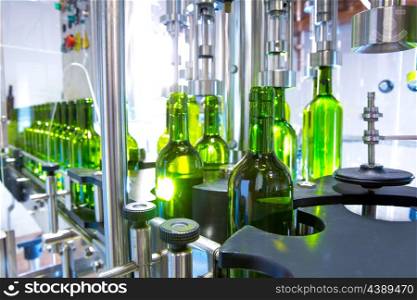 white wine in glass bottling machine at winery