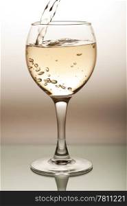 white wine pouring into glass