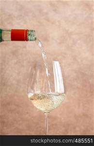 White wine pouring into glass close-up
