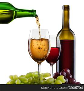 White wine pouring into glass with grape and bottles isolated