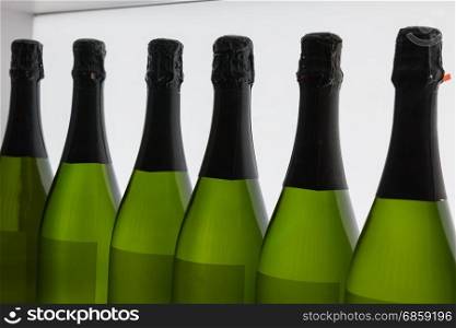 White Wine&rsquo;s Bottles in Line, inside Green Glass